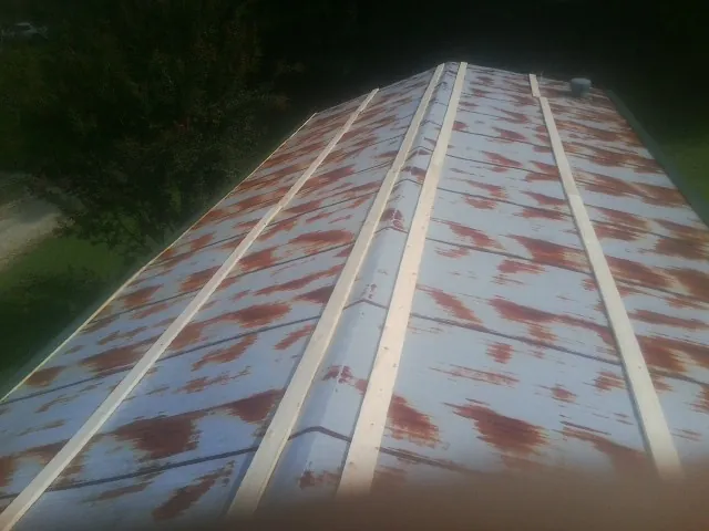 Rusted metal roof panels with new wood purlins before replacement — Storm Damage Roof Repair in Forestburgh by Roofing Brothers